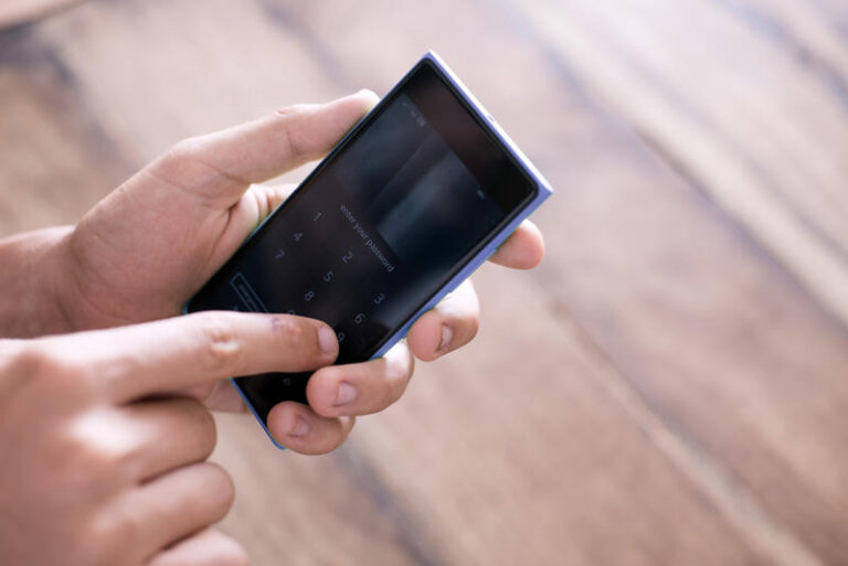 Man using the touch screen on his smartphone